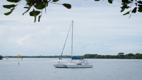 Sailboat-Moored-off-Seaside-Country-Town-Shore-in-Gold-Coast,-Queensland