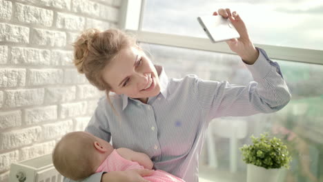 Mujer-Feliz-Tomando-Una-Foto-Selfie-Con-Un-Bebé-Dormido.-Feliz-Maternidad