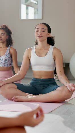 two women practicing yoga meditation