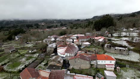 Pueblo-Nevado-Con-Vegetación-En-Invierno-Bajo-Un-Cielo-Nublado-En-Picornio,-Un-Pueblo-En-Galicia