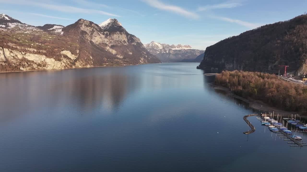 Walensee, Switzerland aerial view, crystal-clear waters, alpine mountains and peaceful marina.