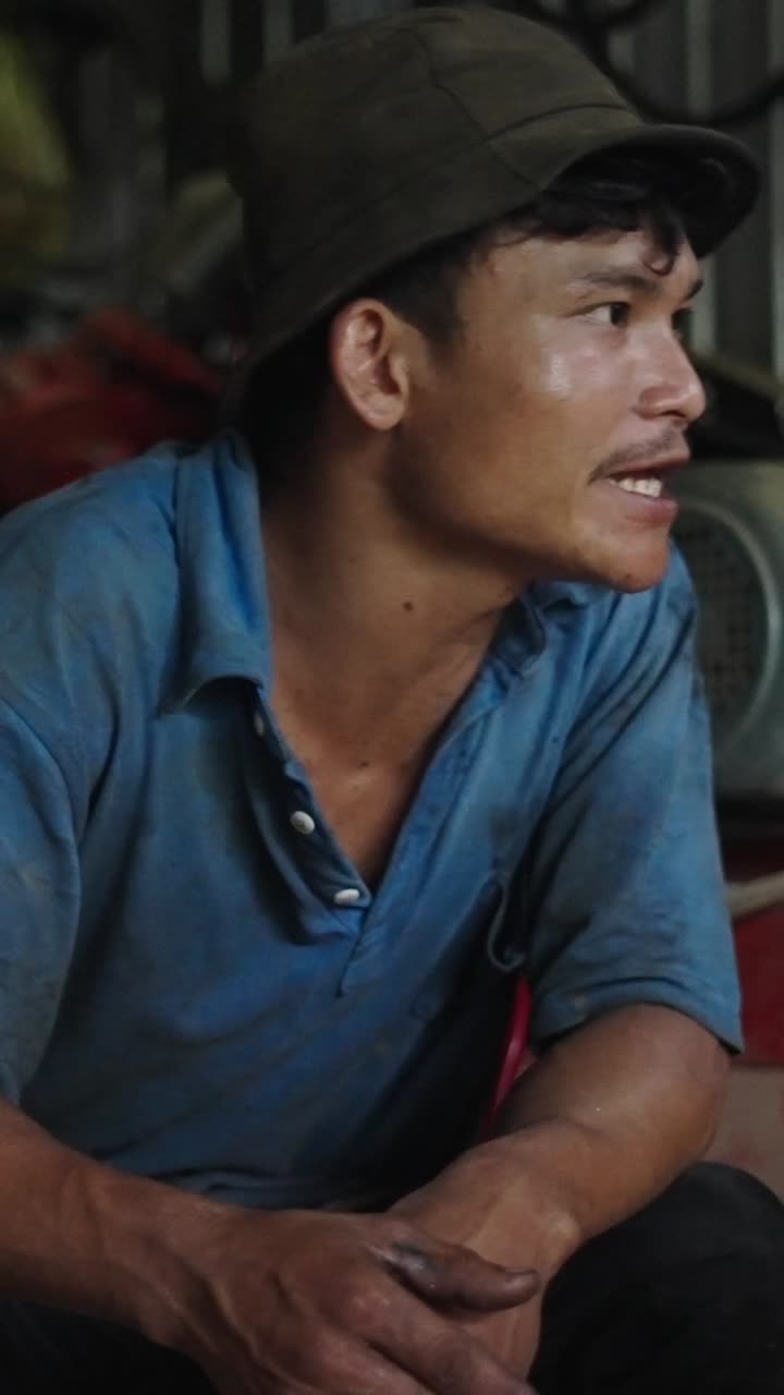 Portrait of a man in a blue shirt and hat