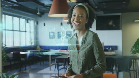 holding tablet with digital animation overlay, woman working in modern office