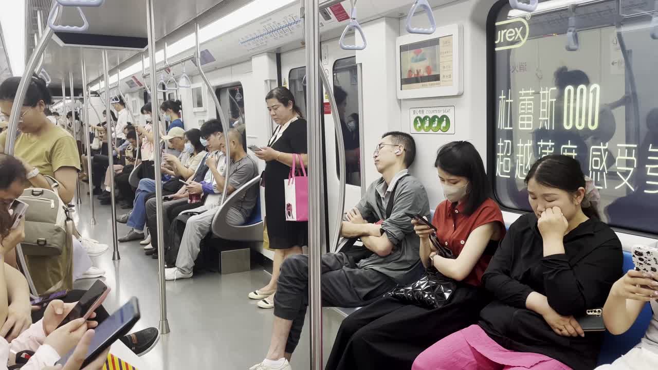 People in Shanghai sitting in the train, everyone is holding a phone typing on an ordinary day in China, static shot, editorial