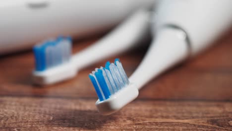 close-up of electric toothbrush heads on wood
