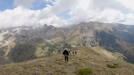 group of friends go down the slope of a mountain in the pyrenees of hueca, spain