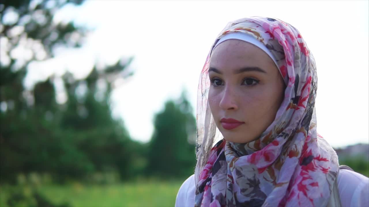 Young Woman Wearing a Floral Hijab in a Park