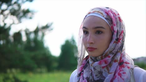 Young Woman Wearing a Floral Hijab in a Park