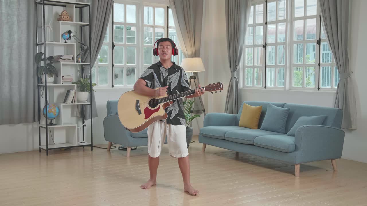 Boy Playing Acoustic Guitar in Living Room