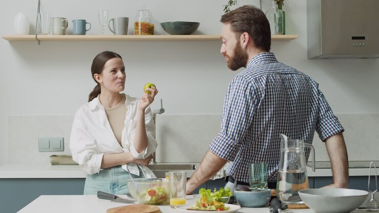 Couple Standing And Chatting In A Modern Style Kitchen