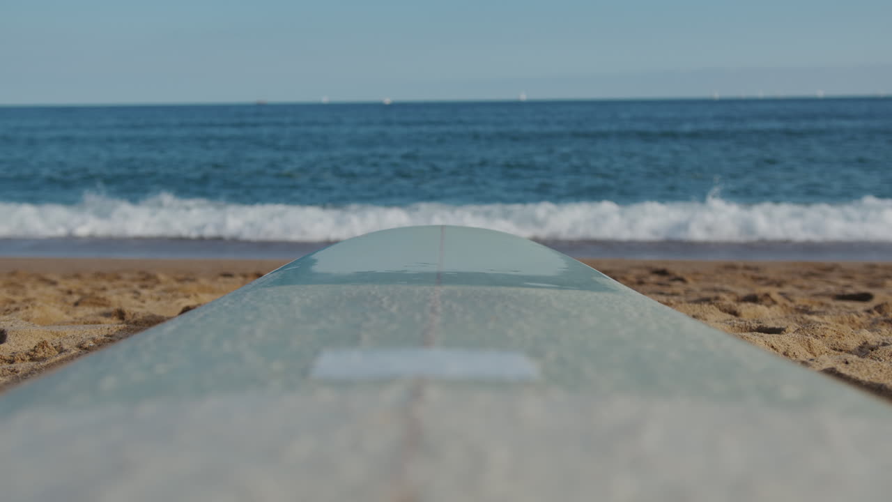 Surfer man walking to the beach at sunset preparing for surfing training and search for waves in Barcelona, spain, water, ocean exercise in sea with board, athletic male holiday or travel in vacation