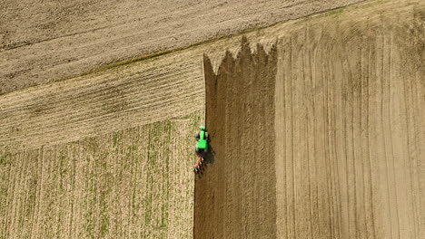 Aerial-View-Of-Modern-Tractor-Ploughing-The-Soil-Before-Planting