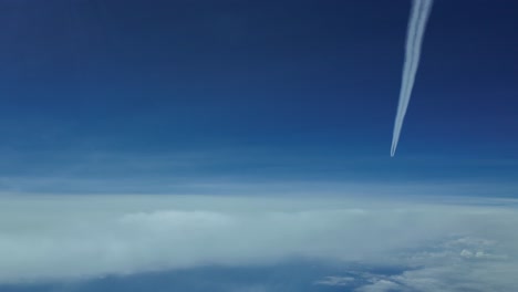 POV-wake-turbulent-of-a-jet-flying-ahead-and-higher,-shot-from-another-jet-cockpit