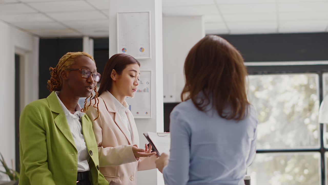 Three Businesswomen Discussing Work in Office