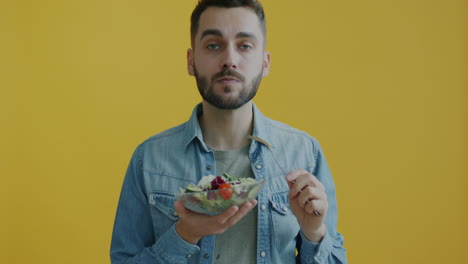 man eating a salad