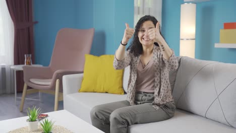 young woman giving greeting and applause to camera.