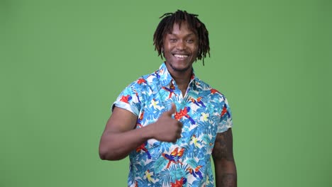 young handsome african tourist man giving thumbs up
