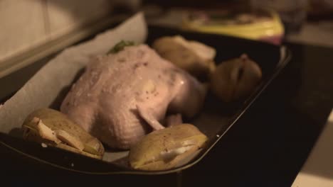 salting the whole chicken in the pan with potatos before cooking it