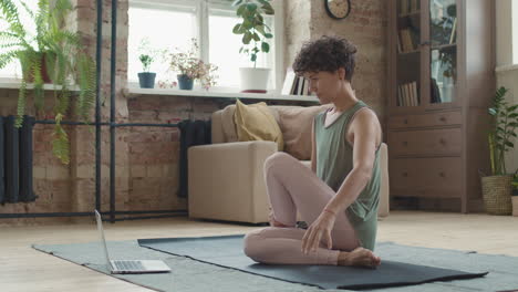 woman practicing yoga at home