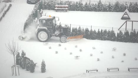 tractor vehicle cleaning the yard from the snow storm