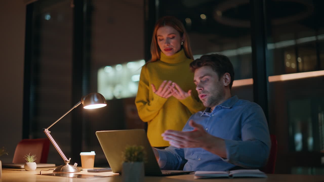 Office team worried failure working together at night workplace closeup
