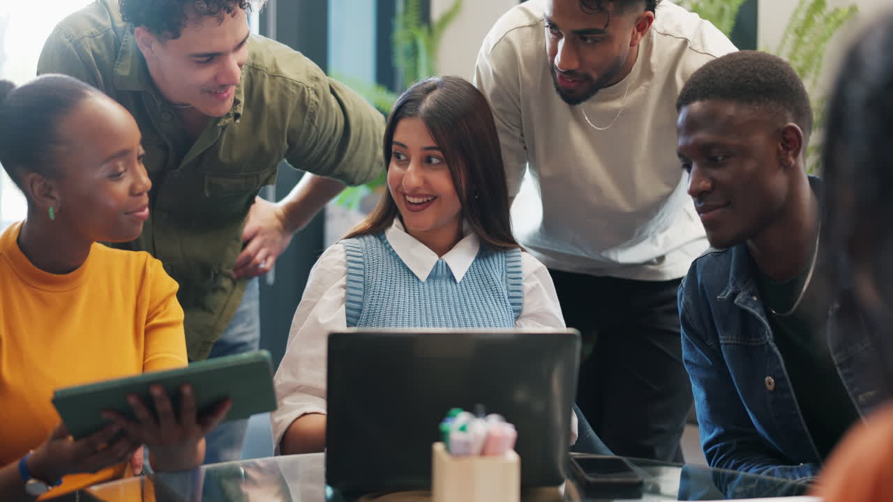 Diverse Group of Young Professionals Collaborating and Laughing in Office
