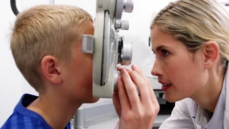 female optometrist examining young patient on chiropter