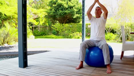 senior man doing meditation on exercise on exercise ball 4k