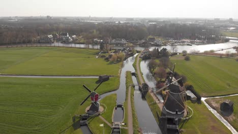 drone shot of a typical landscape in holland with windmills