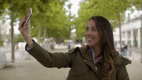 Lächelnde-Junge-Frau,-Die-Draußen-Ein-Selfie-Mit-Dem-Smartphone-Macht.