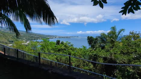 a beautiful scenic view through the trees overlooking ocean and forest from popular belvédère du tahara'a viewpoint in tahiti, french polynesia, south pacific