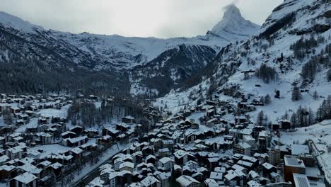 zermatt ski resort and town with the matterhorn and houses in the back ground on a cloudy winter day in the swiss alps mountains