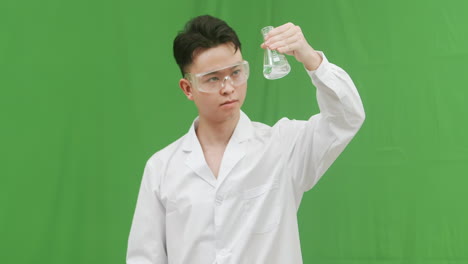scientist in lab coat examining a flask