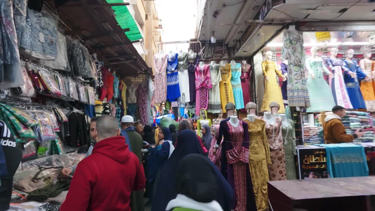 Busy Street Market with People Shopping for Colorful Clothing