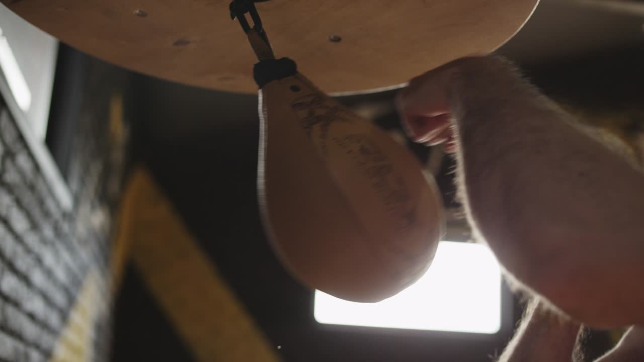 primer plano de manos masculinas golpeando la bolsa de velocidad. los puños del boxeador golpearon la bolsa de boxeo