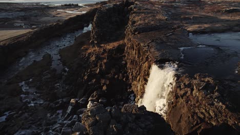 dramatic waterfall oxararfoss in thingvellir national park iceland, aerial