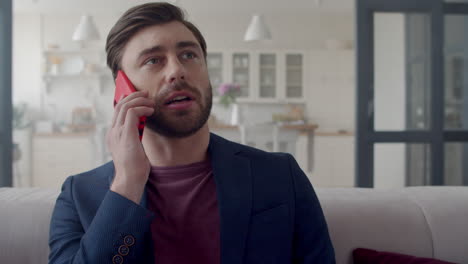 Focused-business-man-making-phone-call-at-home.-Freelancer-speaking-phone.
