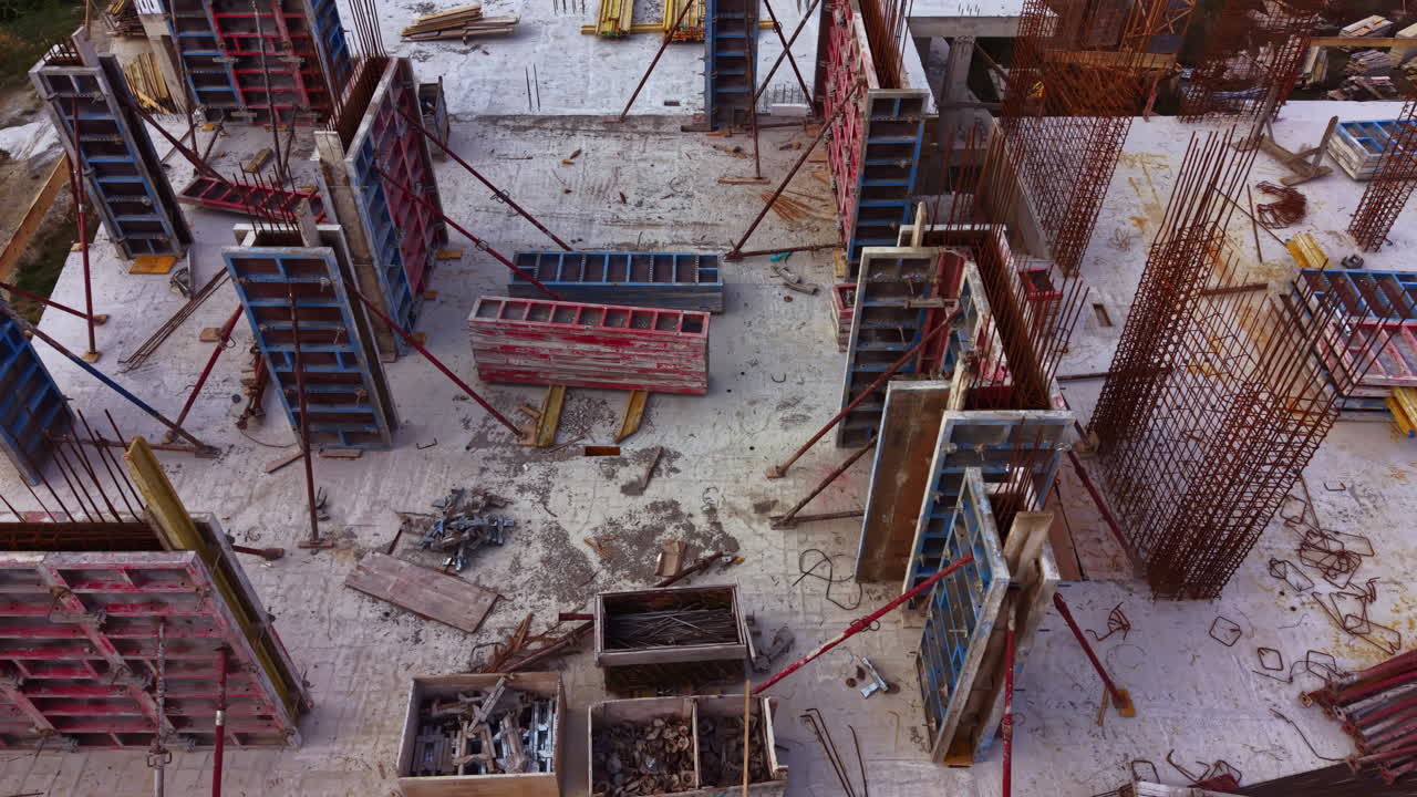 Construction site showcasing intricate framework and vibrant materials at work under bright daylight in a bustling urban environment