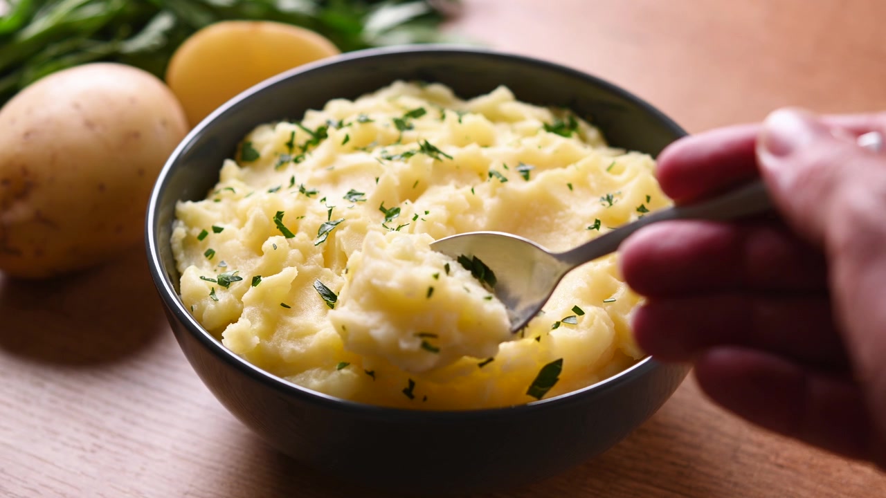Serving creamy mashed potatoes from a bowl
