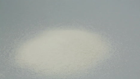 pile of sugar pouring with sugar lumps and injection for diabetes awareness