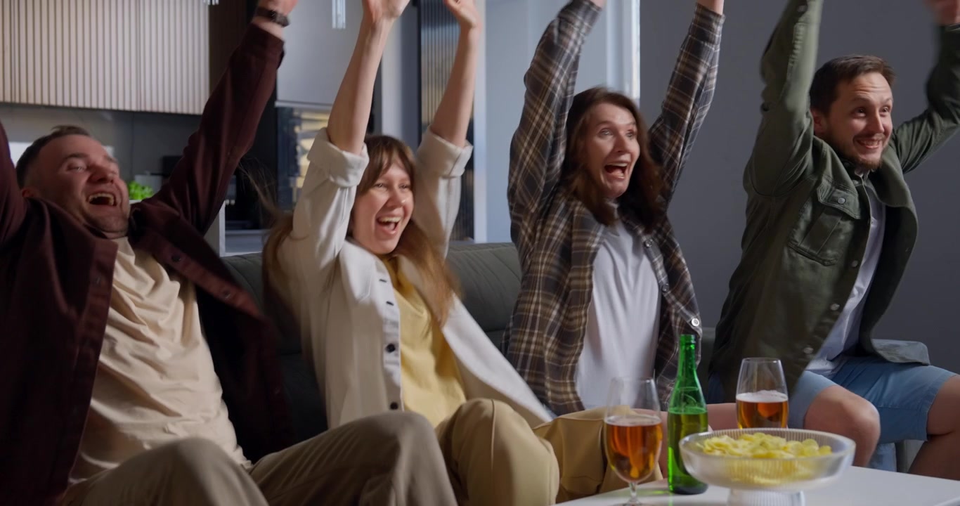 Happy Friends Celebrating a Victory While Watching Television