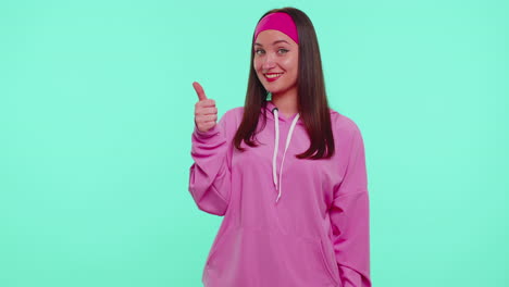 Teen-stylish-girl-in-pink-hoodie-showing-thumbs-up-and-nodding-in-approval,-successful-good-work