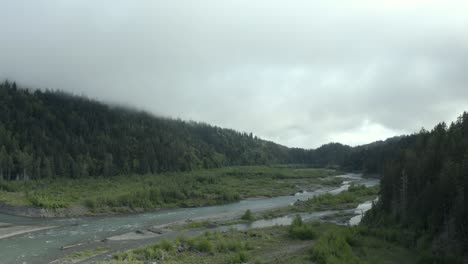 drone footage of beautiful pacific northwest river and misty forest