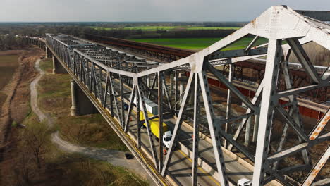 Cars-crossing-steel-bridge-in-west-memphis-delta-regional-river-park,-tennessee,-usa,-daylight,-aerial-view