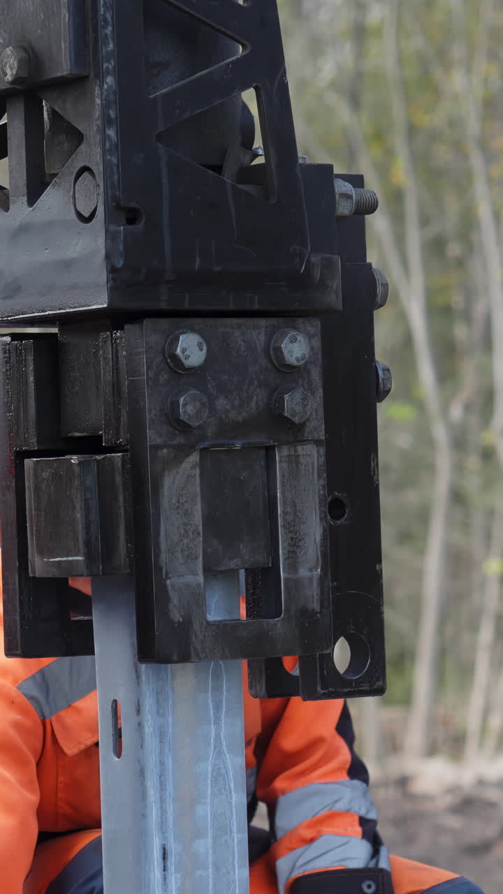 Construction Worker Using Heavy Machinery to Repair a Metal Beam