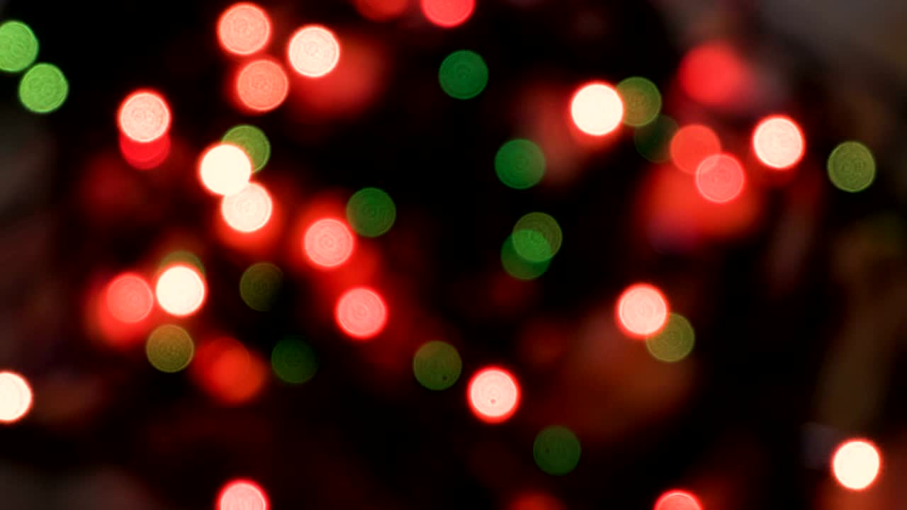 Luzes coloridas piscando em desfoque. Efeito bokeh. Luzes elétricas de árvore de Natal. Clipe de vídeo 4k.