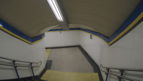 beautiful slow motion shot of the interior of an empty metro station in madrid, spain with a staircase leading to the transport