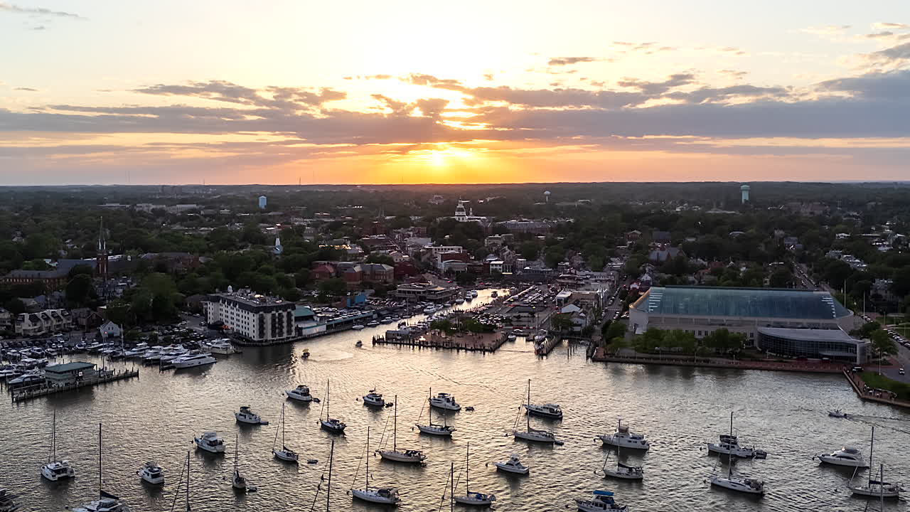 Timelapse af solnedgangen over Annapolis Naval Academy, der kaster et varmt lys over havnen fyldt med forankrede både