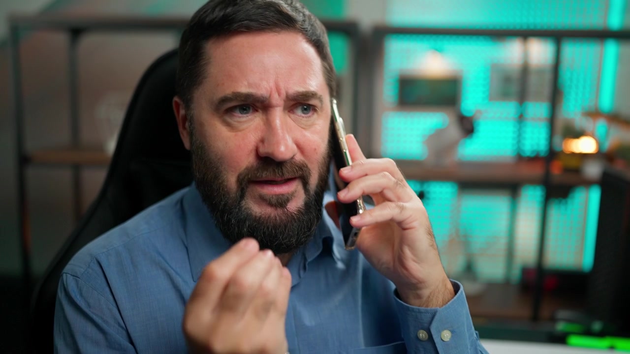 Bearded Man Talking on Smartphone in Modern Office