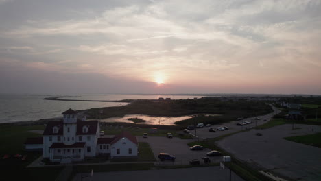 Aerial-view-at-sunset-of-Point-Judith-Lighthouse-on-Narragansett-Bay,-Rhode-Island